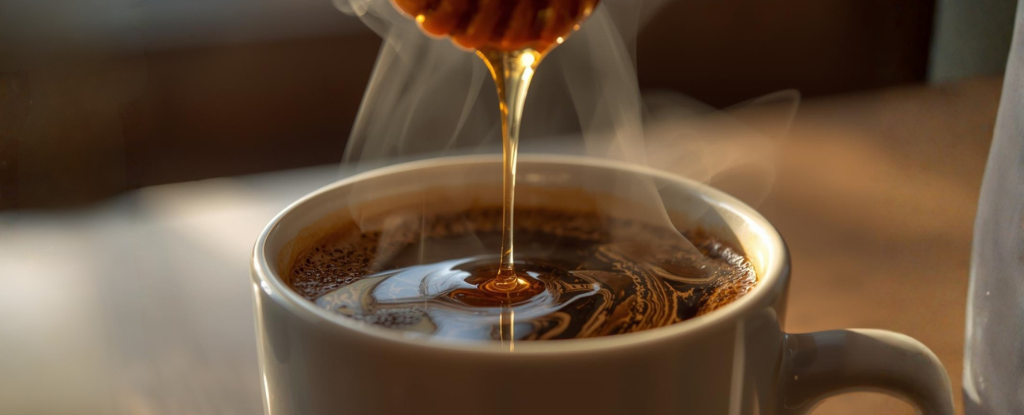 Raw honey mixed into hot coffee cup
