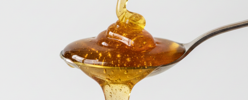 Raw honey spoon showing ideal daily dosage