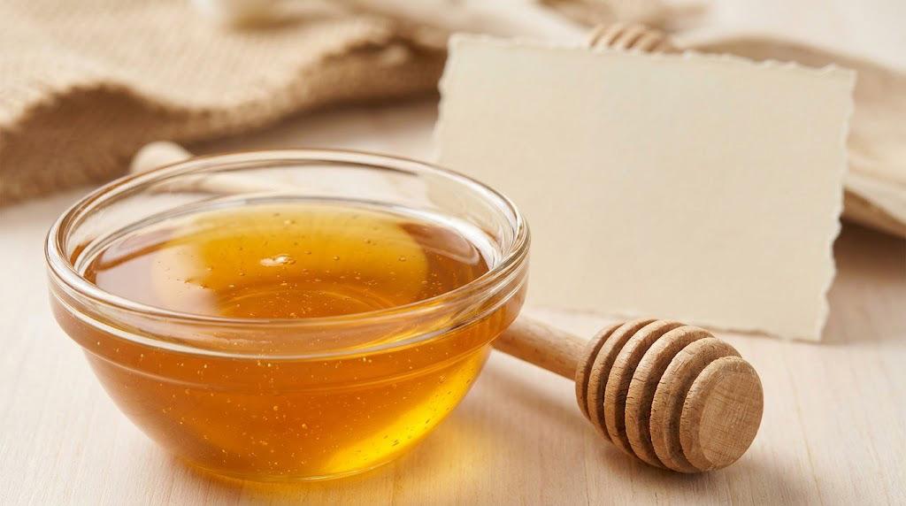 Golden honey beside a blank product label for reviewing ingredients and processing details