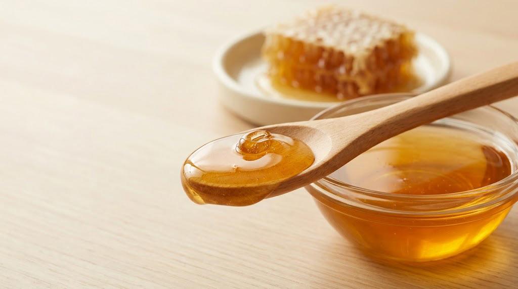 Honey being drizzled over oatmeal during a simple breakfast routine